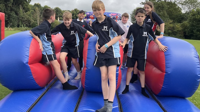 Apollo House pupils on bouncy castle